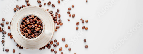 Cup of coffee and coffee beans on a white background with copy space for your text.