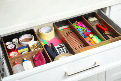 Different stationery in open desk drawer indoors