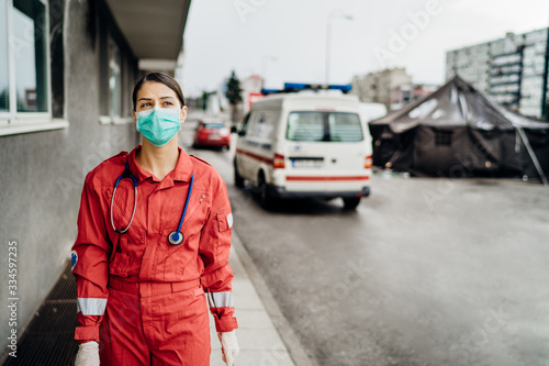 Paramedic in front of isolation hospital facility.Coronavirus Covid-19 heroes.Mental strength of medical professional.Emergency room doctor prepared for virus outbreak.Ready for hard work.Brave nurse