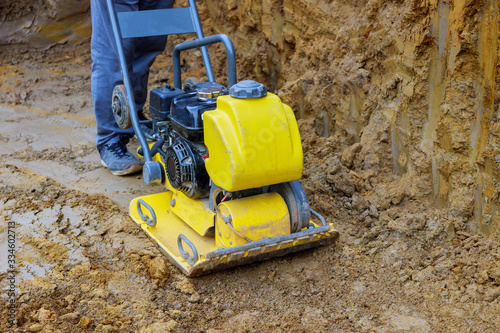 Vibratory plate compactor in construction rammer ground compaction foundation for construction of underground