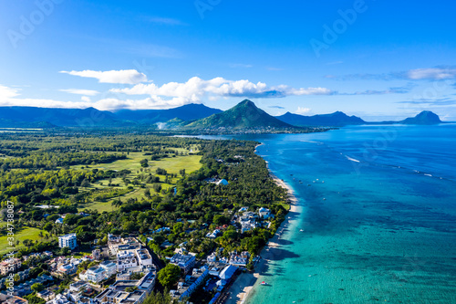 The beach at Flic en Flac with luxury hotels and palm trees, behind the mountain Tourelle du Tamarin, Mauritius, Africa