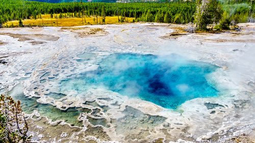 Steam coming from the turquoise waters of the Artemisia Geyser hot spring in the Upper Geyser Basin along the Continental Divide Trail in Yellowstone National Park, Wyoming, United States
