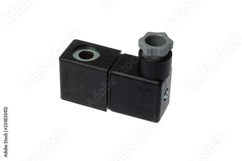 Black solenoid coil with plug socket for control valve, isolated on white