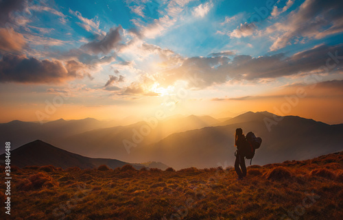 Hiking trough epic mountain landscape with a big backpack, exploring and feeling the freedom of nature