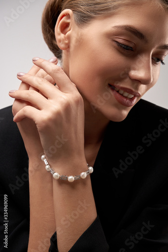 Young model demonstrating bracelet with pearls.
