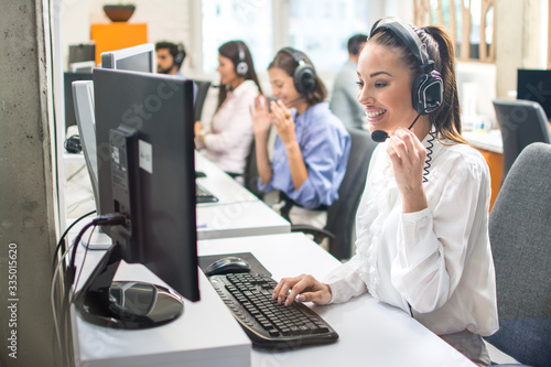 Attractive woman working with customer on hotline support in call center