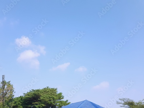 house on background of blue sky and white clouds