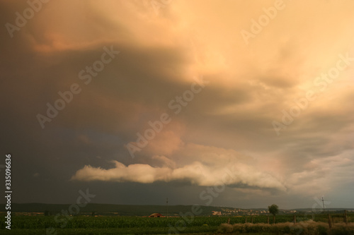 Threatening stormcloud in Transylvania, Romania is illuminated by the setting sun