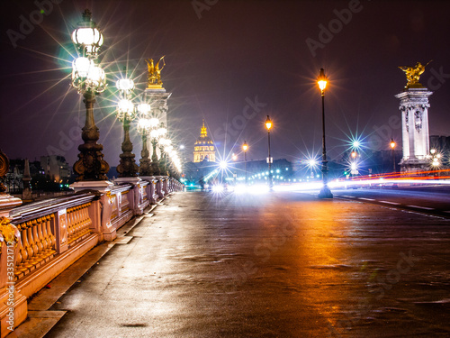 Champs-Elysees in Paris at night with headlights and cars