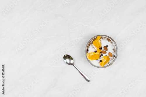 Top view of ice cream in the bowl with sliced orange.
