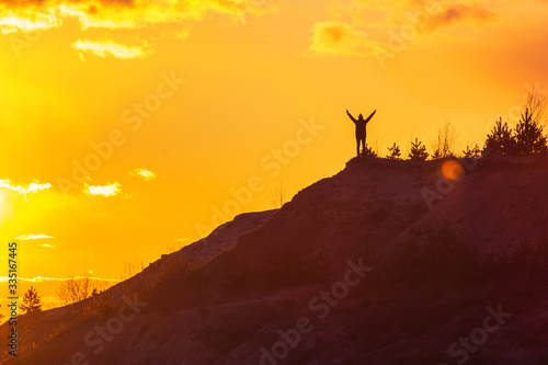 man at the top of the mountain at pink sunset success