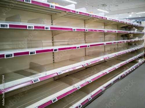 Empty shelves in supermarket store. Food supply shortage in Paris France during covid-19 pandemic. Economic, energy, health crisis and collapse illustration.