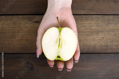 half a green apple in hand healthy food vitamin fruit