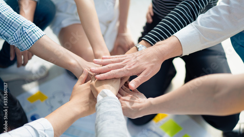 Background of business people bare hands stack join together in the middle with natural sunlight, Concept power of social network charity or volunteer to be unity help and support community.