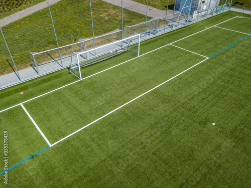 Aerial view of football goal and penalty area. Empty soccer field with white lines.