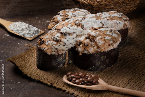 Easter dove bread (colomba Pasquale) made with filling of chocolate and wheat drops on a rustic wooden table.