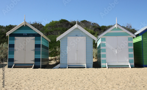 Row of blue beach cabins in Brighton Beach with Hokusaï Wave 