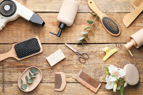 Set of hairdresser's accessories on wooden background