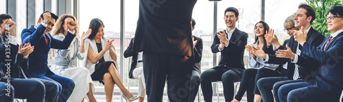 Businessman coach speaker presentation and discussing meeting strategy sharing ideas thoughts.Creative work group of casual business people clapping hands in modern office.Success concept