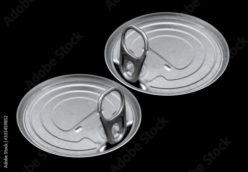 Easy-open food can lid, canister lid isolated on a black background.