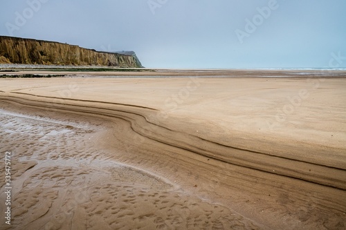 Cap Blanc-Nez surrounded by the beach and the sea under the cloudy sky in France