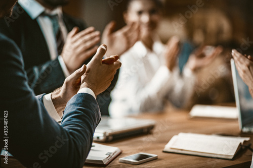 Business People Clapping During Meeting In Board Room