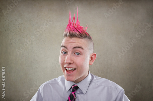 Smiling teen with a pink mohawk haircut