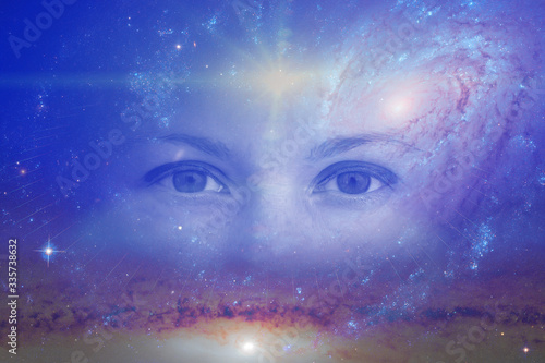 the eyes of a clairvoyant in space against the background of the starry sky and galaxies. The concept of clairvoyance, esotericism or astrology. Elements of this image furnished by NASA