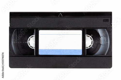 Old black vintage vhs cassette tape front with a blank paper label, front side, top view isolated on white, cut out 80s, 90s retro media aesthetic, magnetic videotape movie storage concept studio shot