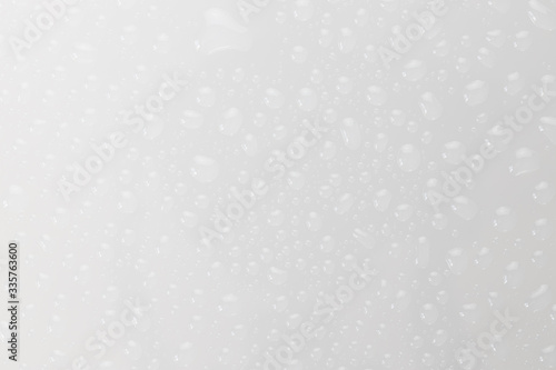 Water drops on glossy glass surface texture abstract background