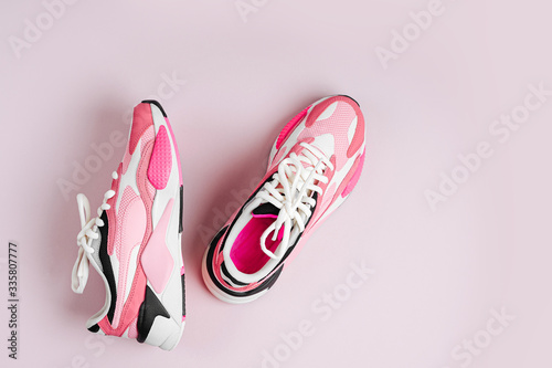 Fashion women's sneakers on a pink background. Female sport shoes. Fitness concept. Top view, flat lay