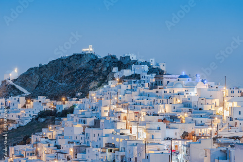 The chora - capital with traditional white houses of Serifos island Aegean Cyclades Greece against a blue sky during blue hour