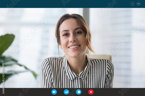 Pc screen view, head shot portrait businesswoman makes videocall looks at webcam consult client distantly, confident business lady lead job interview communicates with applicant by video telephony app