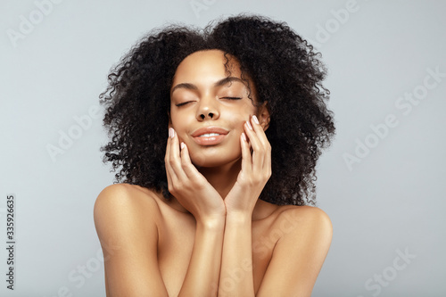 African American skincare models with perfect skin and curly hair. Hydrating and Beauty spa treatment concept.