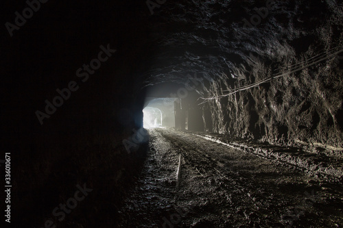 Underground magnezite mine tunnel with fog and light