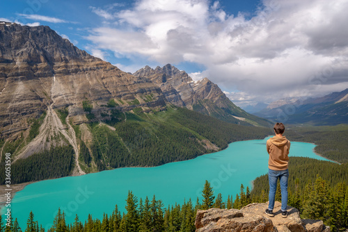 Young man looking at Peyto lake on Icefields Parkway in Banff National Park, Alberta, Rocky Mountains, Canada