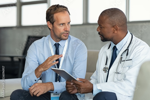 Doctor in conversation with pharmaceutical representative