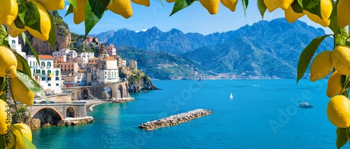 Small town Atrani on Amalfi Coast in province of Salerno, Campania region, Italy. Amalfi coast is popular travel and holyday destination in Italy. Ripe yellow lemons in foreground.