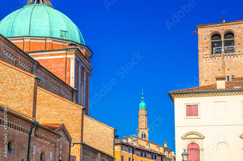 Vicenza Cathedral Roman Catholic church building dome and Torre Bissara clock tower background, old historical city centre of Vicenza city, blue sky background, Veneto region, Italy