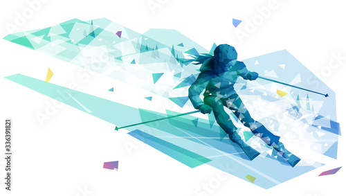 Female skier riding the powder at the mountain landscape