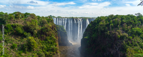 Panorama view with dramatic waterfall and clouds at Victoria Falls, Zambezi River, Zimbabwe, Zambia.