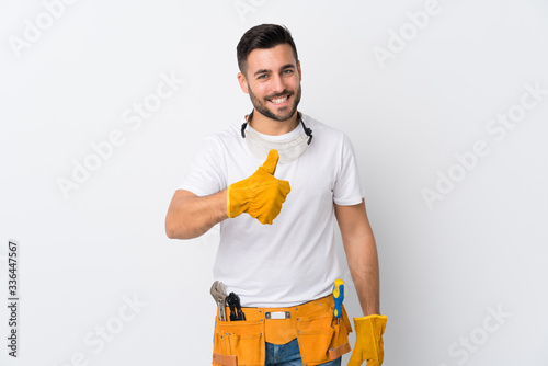 Craftsmen or electrician man over isolated white background giving a thumbs up gesture