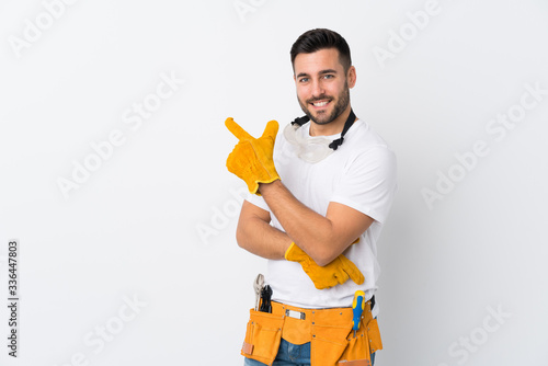 Craftsmen or electrician man over isolated white background pointing finger to the side