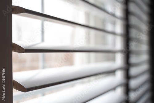 close up of an open window with shutters 