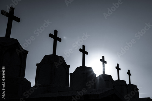 Cemetery or graveyard in the night with dark sky. Headstone and cross tombstone cemetery. Rest in peace concept. Funeral concept. Sadness, lament, and death background. Spooky and scary burial ground.