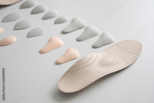 The process of manufacturing individual orthopedic insoles for people with foot diseases, flat feet. Close-up of the insole and accessories for it.