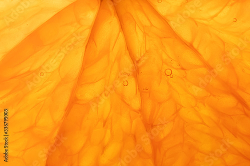 Bright juicy orange pulp close-up. High-quality image is suitable for topics: healthy lifestyle, vitamins, proper nutrition, diet, summer, fresh juices. Background fruit texture.