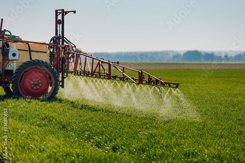 Tractor Spraying Herbicides on Field Agriculture