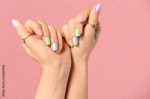 Hands of young woman with beautiful manicure on color background