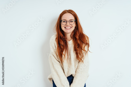 Smiling friendly young woman wearing spectacles